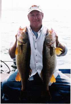 Doug Newhoff Hoists two nice walleyes he caught while fishing his own hand made jigs