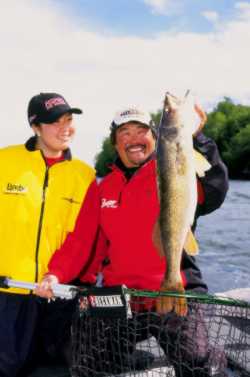 Pro fisherman Ted Takasaki hoists a monster walleye against a rich October sky. From spring through winter, follow Ted’s Trophy Walleye Planner to find big fish on purpose