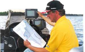 John studies maps and his Lowrance unit before going to far